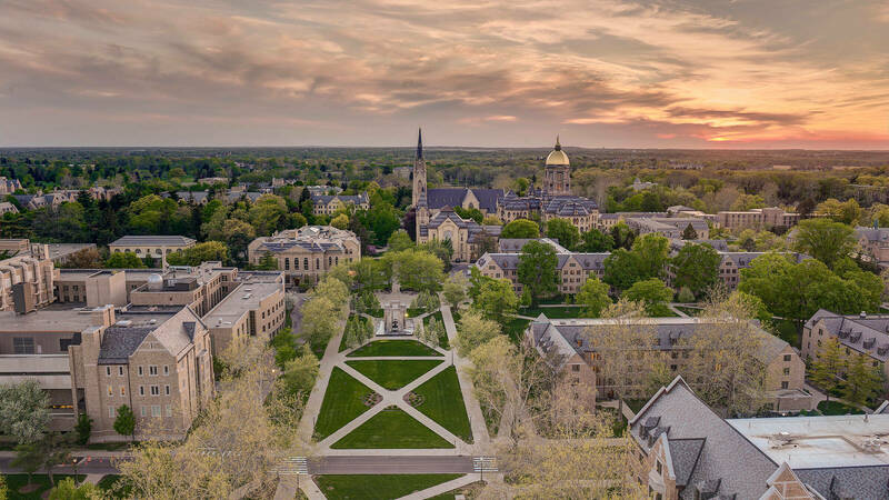A sunset view of campus looking West from the top of the Hesburgh Library.
